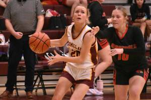 Photo by Kevin Hanson
Enumclaw Highs Camryn Thomas drives to the hoop despite the defensive pressure applied by Ortings Norah Fenton. The action came during the Hornets lopsided December 5 victory over the visiting Cardinals.