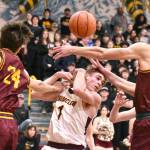 Scrambling for a loose ball during last week's Battle of the Bridge game were Enumclaw's Wyatt Neu (1) and White River's Jace Marecle (24) and Sawyer Bloom (12). Photo by Kevin Hanson