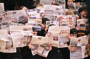 Photo by Kevin Hanson
Dont let anyone tell you no one reads the paper  EHS students held up the Courier-Herald when the White River basketball team was introduced during the Jan. 9 Battle of the Bridge game. Too bad White River had the last laugh, beating the EHS Hornets 51-46.