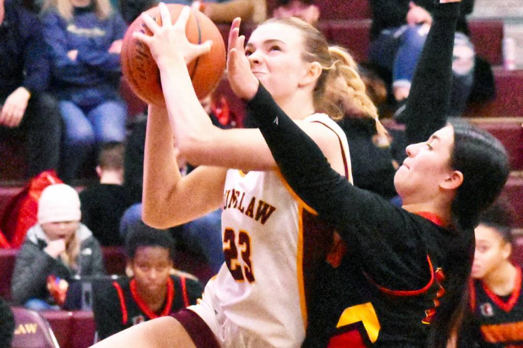 The Enumclaw High girls raced to a 20-point victory Friday night over the visiting Steilacoom Sentinels. Pictured here is Ava Smith (23), fighting through defensive pressure on a drive to the hoop. With the 61-41 win, Enumclaw improved to 7-1 in South Puget Sound League 2A play, keeping a hold on second place. Photo by Kevin Hanson