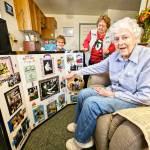 Photo by Ray Miller-Still
Heritage House staff and residents put together a collage of Teresas life for her birthday party. Here, Teresa is showing off a picture of her working as a telephone operator.