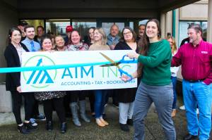 Photos by Ray Miller-Still
Two business ribbon cuttings were held last week, one on either side of the river. First was for AIM, Inc., a local accounting firm, on Jan. 23 (AIM has been in business for a while, but only recently joined the Enumclaw Chamber of Commerce, hence the celebration); the second was for the Rainier Fresh Country Store in Buckley, which recently held a grand opening week.