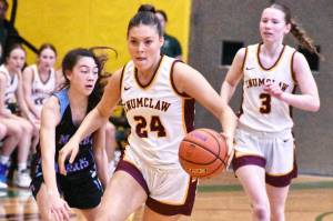 Photo by Kevin Hanson
The Enumclaw High girls basketball team defeated Mark Morris Saturday afternoon, earning a berth in the states Round of 12 and a trip to the Yakima Valley SunDome. In this photo Emma Holt (24) pushes the ball across midcourt while looking for open teammates.