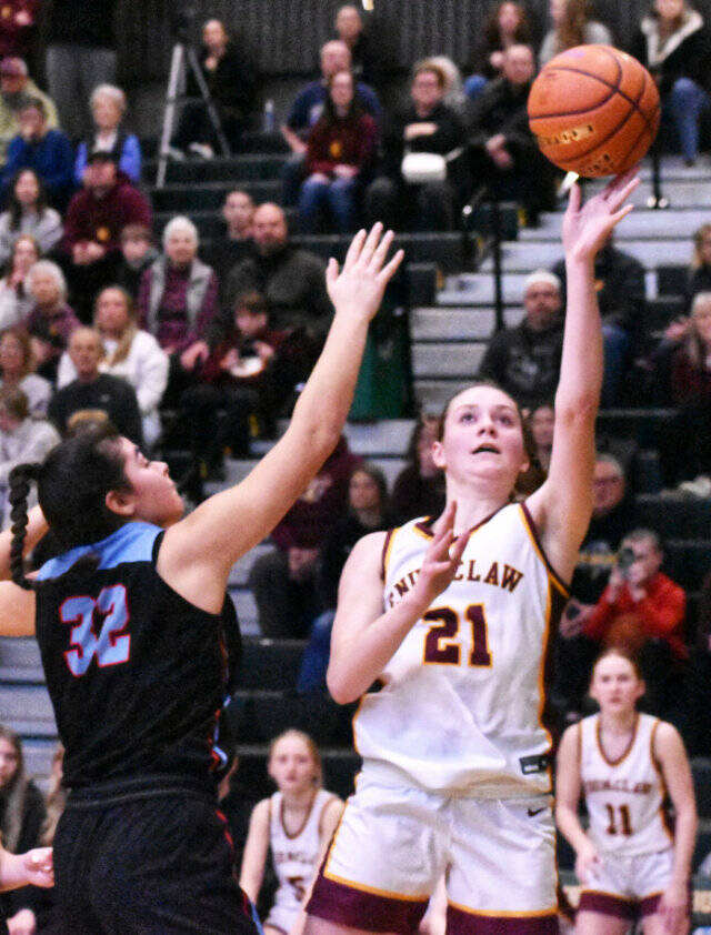 EHS Bella Firnkoess (21) goes up for two points despite pressure from the Monarchs Natalie Mejia. Photo by Kevin Hanson