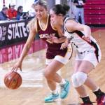EHS Hornet Ellie Schmidt pushes the ball upcourt against her opponent. Photo by Kevin Hanson