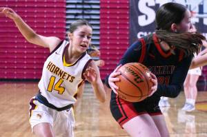 Photo by Kevin Hanson
WRHS Lexie Banks (14) looks to come up with a steal behind a Sammamish opponent.