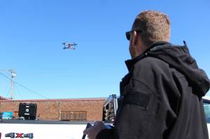 Enumclaw Police Deparment's Commander Mike Graddon flying "Thunderbird," his bright orange drone. Photo by Ray Miller-Still