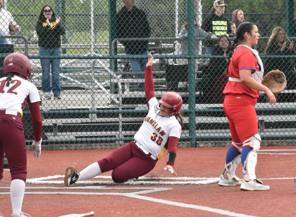 Photo by Kevin Hanson
Enumclaw Highs Kaylie Plyler slides safely home, with Nadia Flaherty looking on, during the Hornets district victory over Washington High in Lacey.