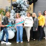 Chamber of Commerce Executive Director Kerry Solmonson, Rainier Foothills Wellness Foundation Executive Director Sara Stratton, Program Coordinator Deanna Kuzaro, Board Vice President Tammi Voorhees, Treasurer Pat Kollen, President Suzanne Lewis, Elaine Parks, and Becky Olness celebrate the nonprofits new location on Griffin Avenue with a ribbon cutting. Photo by Ray Miller-Still