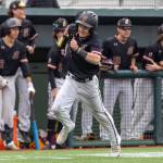 This is Drew Francis rounding third base sprinting for home to bring the score to 2-0 Enumclaw in the bottom of the 2nd inning. Drew was able to score after Landon wall hit a line drive to left field. Photo by Travis McQueen / travis-mcqueen.com