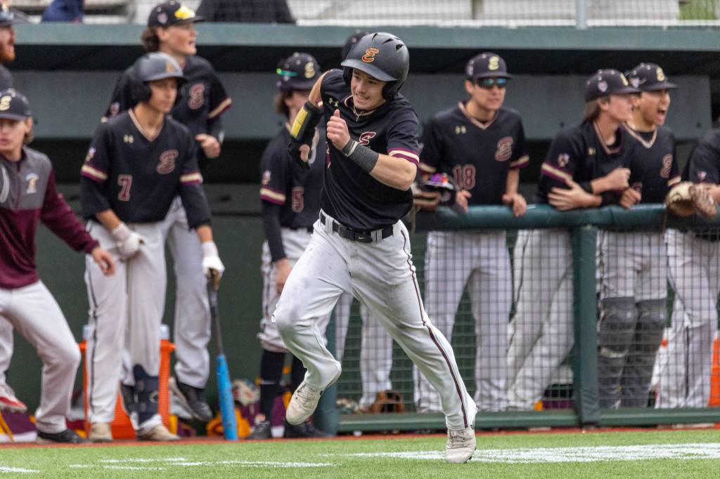 This is Drew Francis rounding third base sprinting for home to bring the score to 2-0 Enumclaw in the bottom of the 2nd inning. Drew was able to score after Landon wall hit a line drive to left field. Photo by Travis McQueen / travis-mcqueen.com