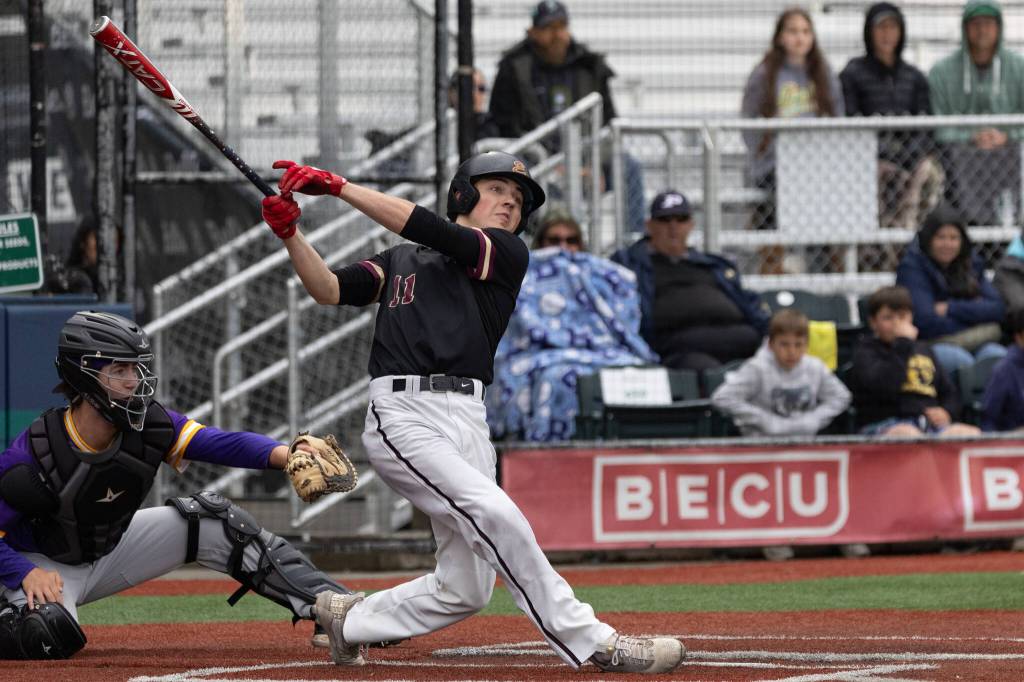 Photo by Travis McQueen / travis-mcqueen.com 
EHS baseball team was finally bested by Columbia at Joe Martin Stadium in Bellingham last weekend, 3 - 2. Pictured is Garett Chavis hitting a ball to right field in the bottom of the 6th inning.