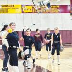 Enumclaw softball junior Bella Aubrey and other members pose for the camera during an indoor practice on March 12. According to climate-data.org, there was no rain that day, but Coach Quinn Haney could not confirm if this was the reason they practiced inside. Photo by EHS softball