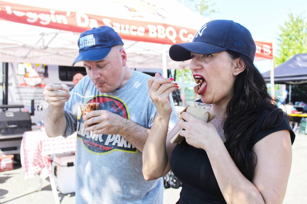 Angelica and Duwane Smith walking through Ten Trails and enjoying a Slaw Sundae from Hoggin Da Sauce BBQ.