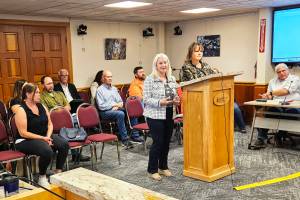 Photo by Ray Miller-Still
Krista Swain and Somer Johnson at the Enumclaw City Council podium during the Aug. 12 meeting. At the bottom left is Jessica, who is a graduate, a year and a half sober, and is now able to visit her children.