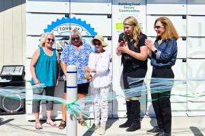 Photo by Ray Miller-Still
Cutting the ribbon for Carbonados new refrigerated food locker is Roberta Doodie Kyllonen, 90, who is the citys longest volunteer at the year-old food pantry. Also pictured, left to right, is Shelly Wright and Denise Vesey, co-founders of the food pantry, GoodRoots CEO Stacey Crnich, and Congressional Rep. Dr. Kim Schrier.