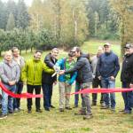 Numerous representatives of various municipal and county governments, plus officials of various county and state departments, gathered on the Enumclaw Golf Course on Oct. 8 to officially cut the ribbon on a Boise Creek re-route project. Included is Enumclaw Councilmember Tom Sauvageau (second from the left) and Enumclaw Mayor Jan Molinaro (fourth from the left).