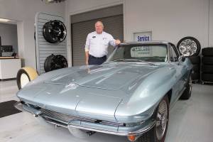 Alan Gamblin, who took over his fathers dealership in 1985, stands in his car shop next to his personal 1964 Corvette in 2019 while celebrating being 50 years in business on the Plateau. Photo by Ray Miller-Still