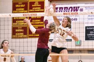 Photo by Kevin Hanson
White River and Enumclaw met for the second time this season on the volleyball court and, for the second time, it was the Buckley squad celebrating a straight-set victory. With the Oct. 24 win, White River stayed perfect in league play (14-0) while Enumclaw remained a step back (11-2) in the 3A North Puget Sound League standings. In this photos WR standout Kianna Rohner (#12 in white) battles for a kill at the net.
