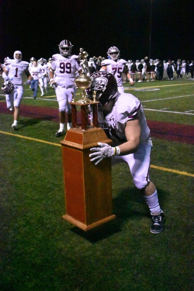 PHOTO BY KEVIN HANSON
Friday night brought the much-anticipated 2024 edition of the Battle of the Bridge, the annual football game between Enumclaw and White River high schools. Here, at the conclusion of the contest, Enumclaw players, led by senior Fernando Reyes Villasenor, rush to hoist the traveling trophy that stays with the winner until next season. Enumclaw kept its winning streak intact with a 41-13 triumph.