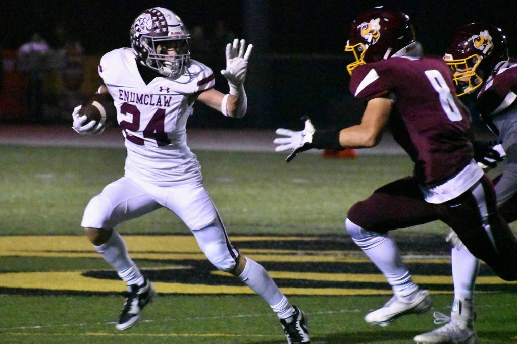 PHOTO BY KEVIN HANSON
Enumclaw running back Louis Chevalier (24) looks to fend off White River tacklers led by Ray Palmer (8) during the games early stages.