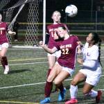PHOTO BY KEVIN HANSON White River and Enumclaw High played back-to-back soccer games the evening of Nov. 7 at Harry Lang Stadium in Lakewood. At stake was a district victory and guaranteed berth into the Class 3A state tournament. Both squads fell in hard-fought games, setting up a Hornet-Hornet, Saturday night showdown for the districts seventh and final state entry. In this photo, a header by White Rivers Jordyn Daigle (22) keep play alive as teammates Riley Soule (14) and Belle Knauss move in.