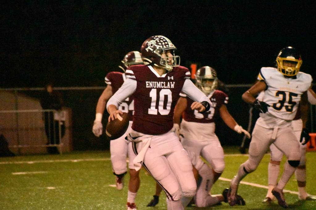 PHOTO BY KEVIN HANSON 
In their game against the Suns, EHS quarterback Gavin Trachte rolls to his right before tossing a short pass that turned into a touchdown reception by Rodarte in the first quarter.