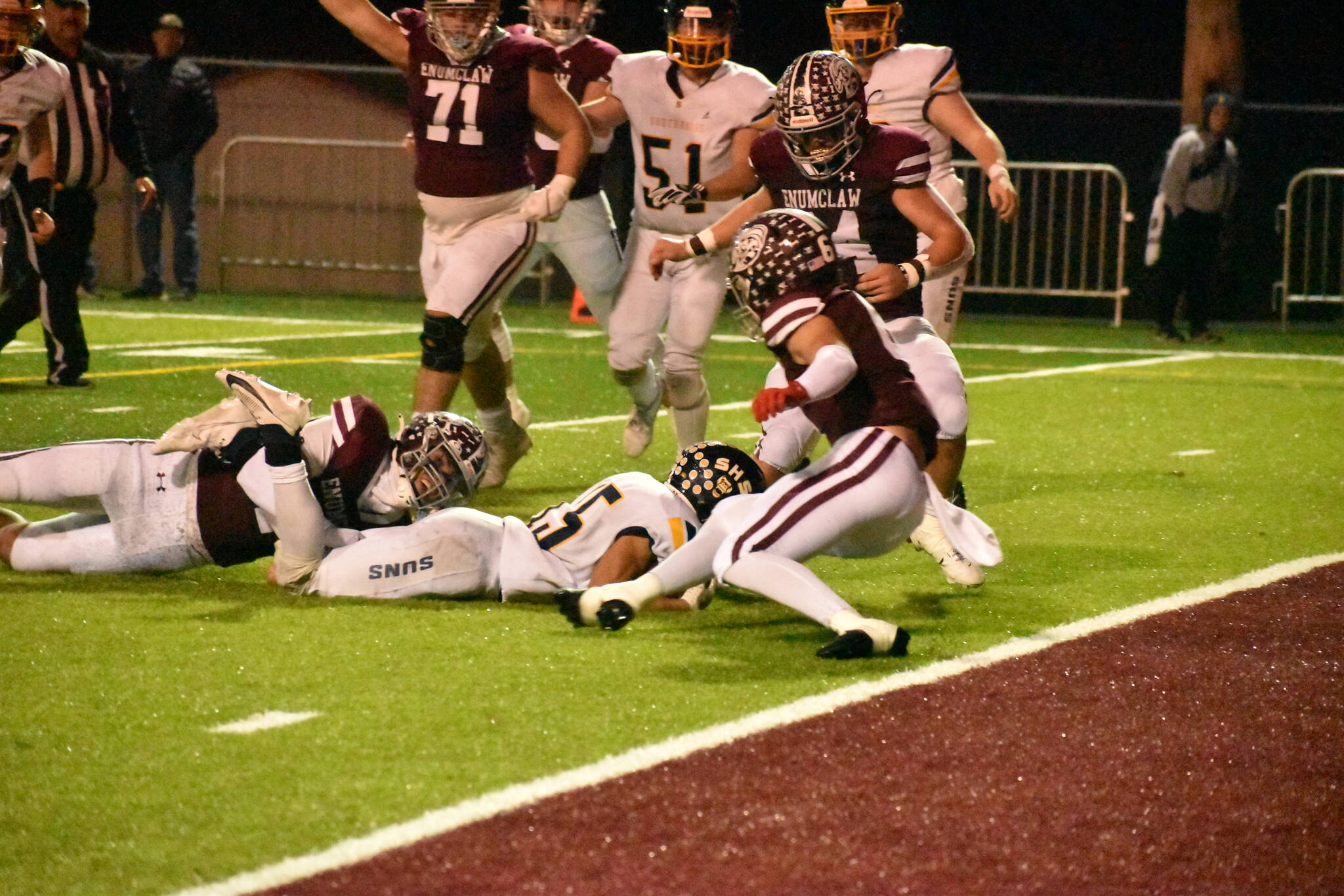 PHOTO BY KEVIN HANSON Pictured is a key play in Enumclaws Friday night whitewashing of the visiting Southridge Suns. The only time the Suns moved close to the end zone, the Hornets Cooper Rodarte wrapped up the legs of the Southridge ballcarrier on fourth down, giving EHS the ball.