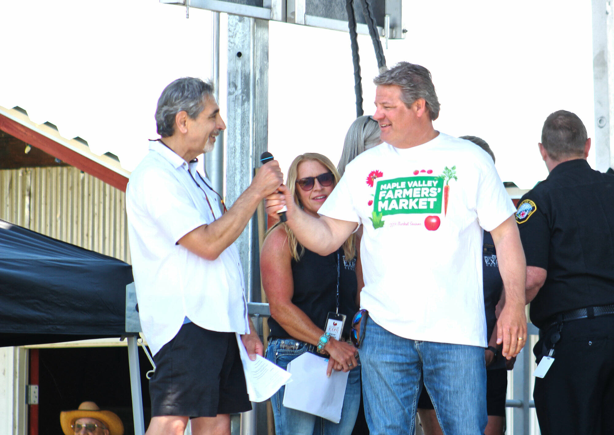 Photo by Ray Miller-Still
King County Councilmember Reagan Dunn often visits Enumclaw for large events like the King County Fair. Here he is receiving the mic from Enumclaw Mayor Jan Molinaro at the fairs opening ceremony.