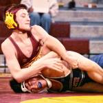 Pictured is Conner Henry (yellow headgear) during a Dec. 18 match against Decatur High; he eventually won with a pin in the third period.