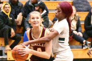 PHOTO BY KEVIN HANSON
Making her way to the basket, despite a serious foul by a Todd Beamer player, is Enumclaw Highs Isabella Pohlman.