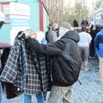 Even though the ceremony was about Mike Lane and his new home, the Vietnam vet stepped away from the speeches to find a coat for a young woman.