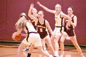 The seasons first edition of the Hornet-Hornet girls basketball game took place Jan. 8 in the White River High gymnasium and saw the host team emerge with a 69-31 victory. In this photo, EHS defenders (from left) Kaidyn Johnson, Clare Largent (#5) and Ava Smith look to shut off a passing lane to White Rivers Vivian Kingston. PHOTO BY KEVIN HANSON