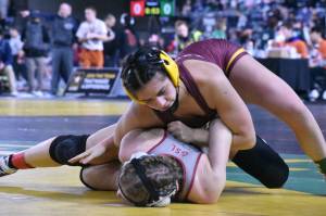 Photo by Kevin Hanson
White Rivers Lilyana Lamothe pinned all four of her opponents during Mat Classic, earning a Class 3A championship in the 130-pound division. In this photo, she dominates Mariah Denney from University High (Spokane Valley).