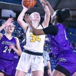 Photo by Kevin Hanson
Vivian Kingston (#34), sandwiched between Garfield defenders, puts up a shot during White Rivers state tournament game in the Tacoma Dome. The senior ended her Hornet career with a flourish, scoring 12 points and pulling down 16 rebounds.