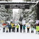 Eleven demonstrators cheered for the Forest Service and National Park Service under the enterence to Mount Rainier National Park last Saturday. All were local volunteers, and many said they hike local trails often, if not every day. Photos by Ray Miller-Still