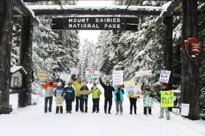 Eleven demonstrators cheered for the Forest Service and National Park Service under the enterence to Mount Rainier National Park last Saturday. All were local volunteers, and many said they hike local trails often, if not every day. Photos by Ray Miller-Still