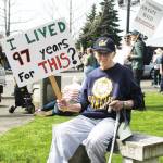 Chants of "Hands off" and "This is what democracy looks like" dominated the corner of Porter Street and Griffin Avenue last Saturday between noon and 2 p.m. Among the protestors was Dore Aitken, 97, who believes that public funds for children and seniors is not government waste. Photo b