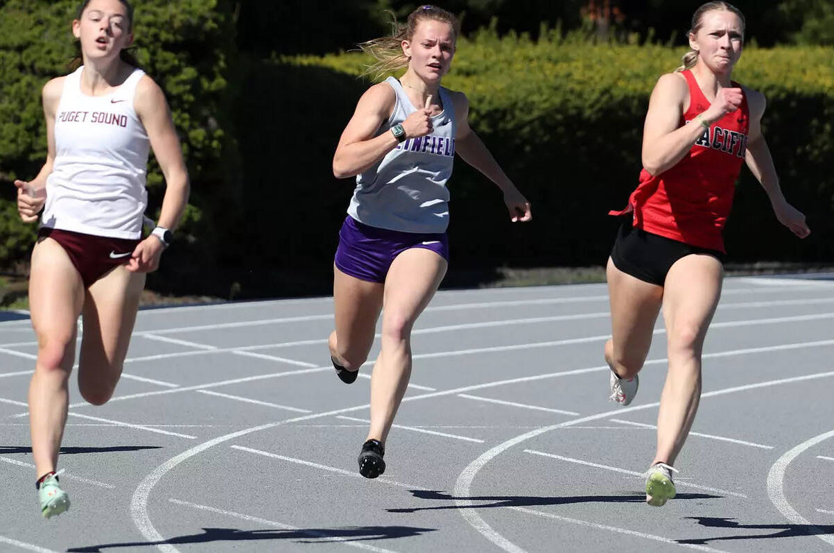 Former Enumclaw High Hornet and current Linfield University student Kira Hawaaboo, center, broke her own school record by 211 points while successfully repeating as heptathlon champion at the Northwest Conference Multi-Event Championships. Photo courtesy Linfield University