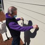 Photo by Ray Miller-Still 
Construction expert Will Martin taking some measurements of the siding of a house in Enumclaws Suntop Farms.
Construction expert Will Martin taking some measurement of the siding of a house in Enumclaws Suntop Farms. Photo by Ray Miller-Still