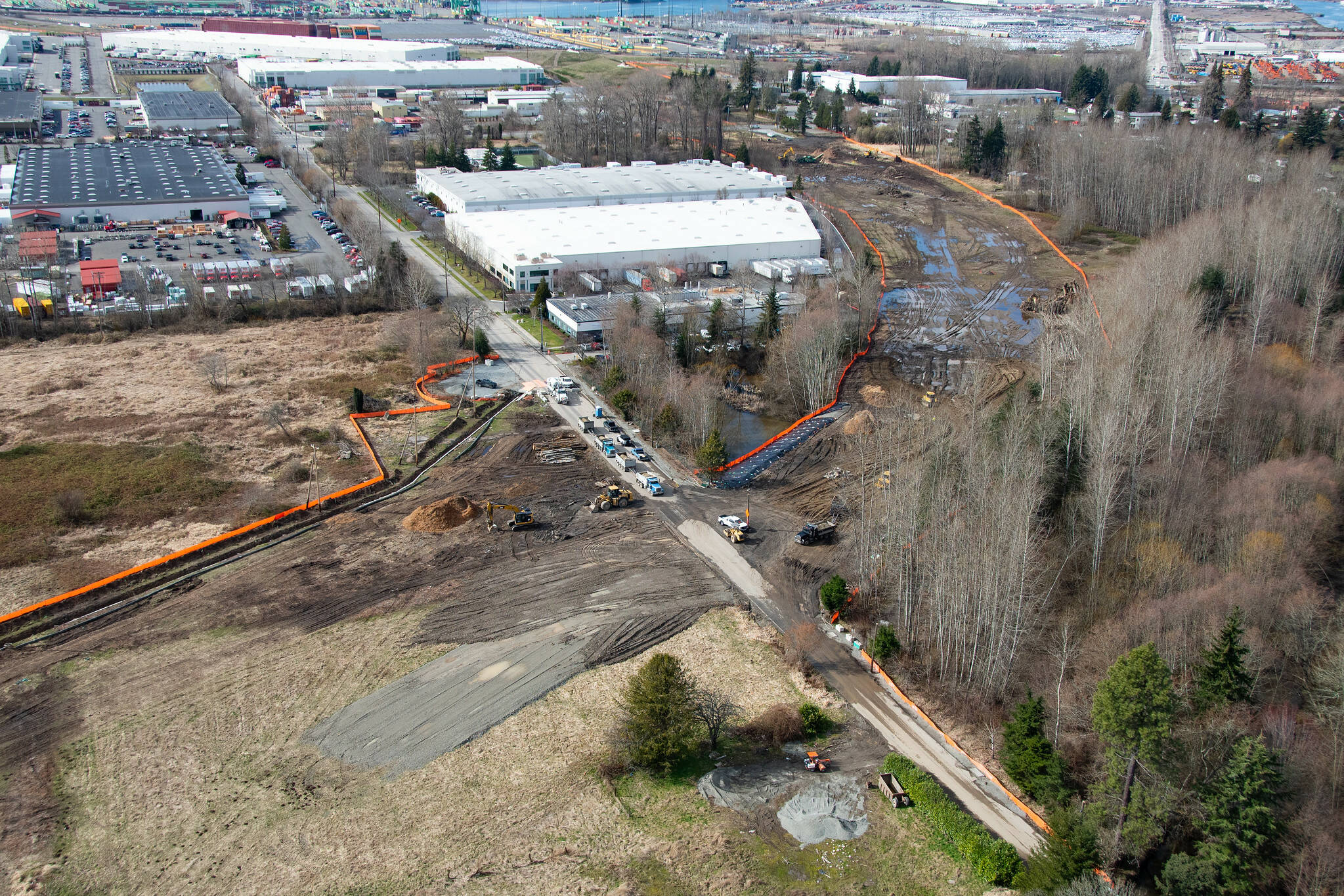 This photo, looking west toward the Port of Tacoma, shows where the new SR 167 expressway weaves its way between industrial warehouses. Running through the center of the photograph is 8th Street East. This is part of the SR 167 Completion Project, and now involves installing signs on SR 167 and SR 410. Photo courtesy Washington State Department of Transportation