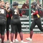 PHOTO BY KEVIN HANSON 
Enumclaw Highs Lila Schmidt is greeted by teammates after crushing a game-ending home run during a May 15 district victory over Heritage High. The win, at the Regional Athletic Complex in Lacey, was the Hornets first step toward earning a berth in this weeks Class 3A state fastpitch tournament.