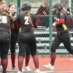 PHOTO BY KEVIN HANSON Enumclaw Highs Lila Schmidt is greeted by teammates after crushing a game-ending home run during a May 15 district victory over Heritage High. The win, at the Regional Athletic Complex in Lacey, was the Hornets first step toward earning a berth in this weeks Class 3A state fastpitch tournament.