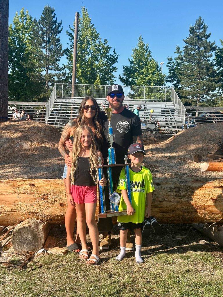 Photo by Ashley Britschgi 
Billy Clinkingbeard took his 11th All Around Logger win this year. With him is his wife Baratyah and children Liam and Mia.