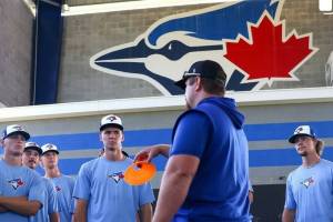 PHOTO COURTESY TORONTO BLUE JAYS 
Enumclaw product Dylan Watts joins Blue Jays coaches and other drafted players just days after being drafted by the major league team. Watts is in the center, directly behind the orange cone.