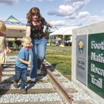 Photo by Ray Miller-Still
Douglas Doc Taits great-grandkids Welles and Brooklyn Crowther, and their aunt Brenna Tait Colo, enjoying the railroad track feature at the new Foothills Trail pavilion.