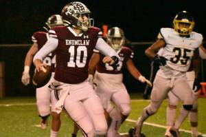 FILE PHOTO BY KEVIN HANSON 
Enumclaw quarterback Gavin Trachte looks for an open receiver during a game last fall. Now a senior, he is back to direct the Hornet offense.