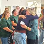 It was an emotional moment for Tanie Valison (pictured here hugging her daughter), her family, and her friends after the guilty verdict was read. Many of her group wore green, Nick Valisons favorite color, throughout the trial. Photo by Ray Miller-Still