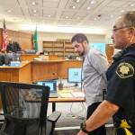 Black Diamond resident Andrew Baim being led out of the courtroom after the jury started deliberating his verdict. Photo by Ray Miller-Still