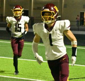 PHOTO BY KEVIN HANSON 
Hornet receiver Parker Fry returns to the sideline after the first of his two touchdown receptions against Thomas Jefferson High.